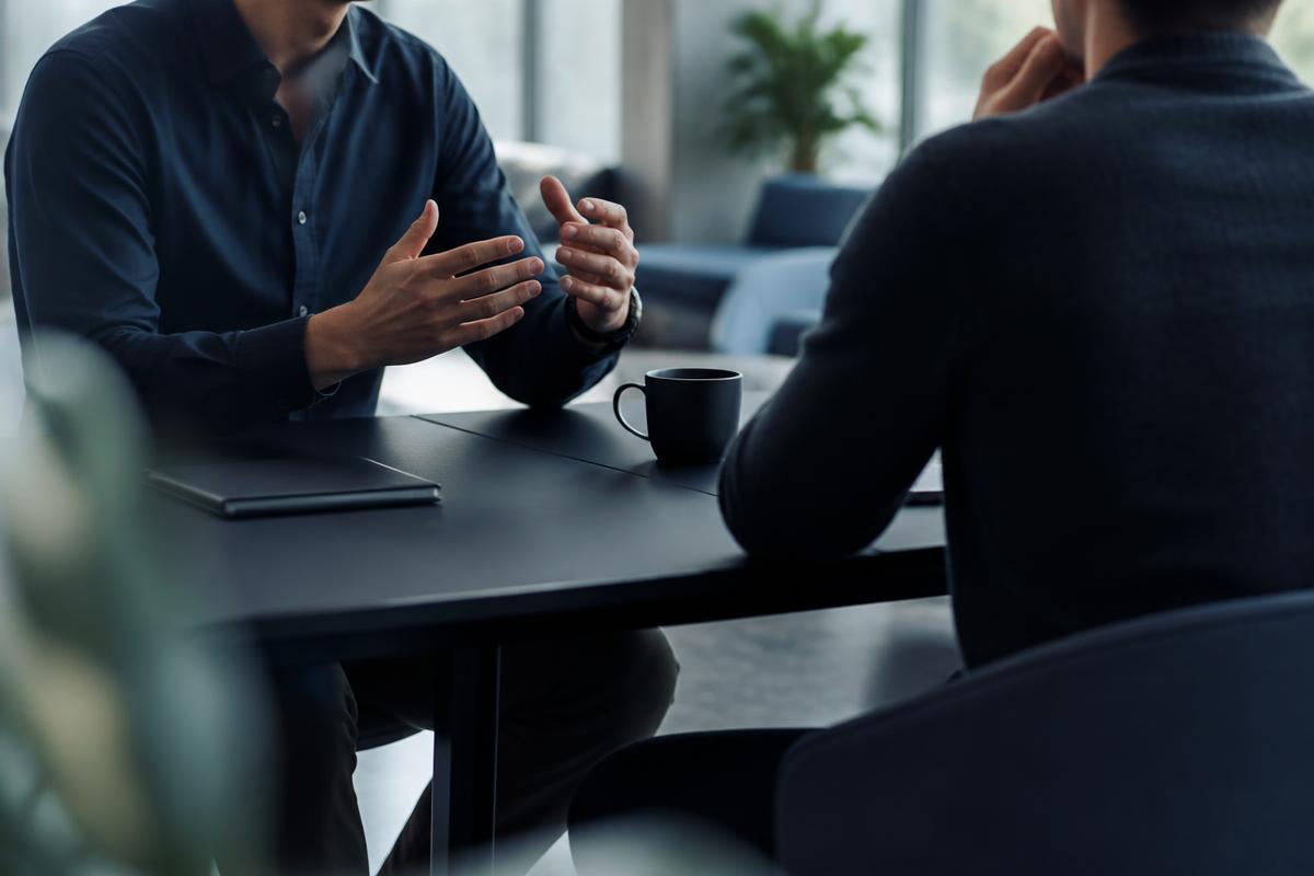 A confidential recruitment conversation across a desk